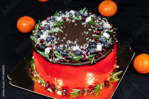 Christmas Day Cake Decoration. Holiday Cake round shaped on a gold substrate on black background.