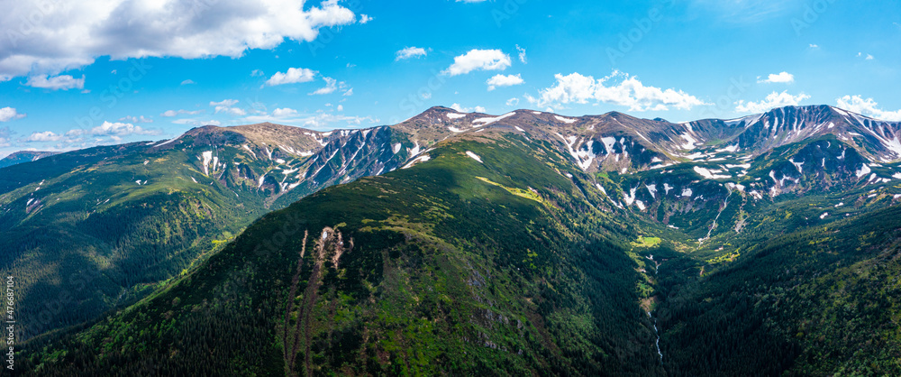 Fototapeta premium Panorama of beautiful countryside of Switzerland. Sunny afternoon. wonderful springtime landscape in mountains. Grassy field and rolling hills. rural scenery