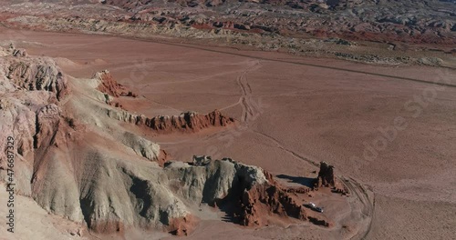 Retro camper parked in a remote area near Goblin Valley State Park, Utah, aerial drone shot
