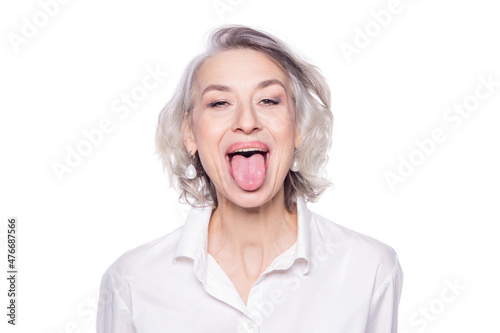 Shot of a beautiful mature woman having fun and teasing sticking out her tongue isolated on white background