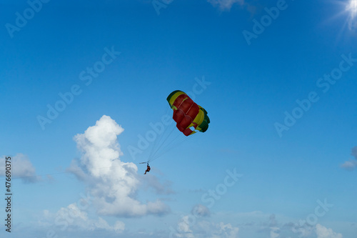 Couple under parachute hanging in mid air.