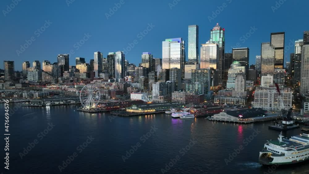 Cinematic 4K aerial drone night trucking shot of Alaskan Way waterfront with Pike Place, The Seattle Great Wheel, Aquarium, Bainbridge Ferry by Elliott Bay, downtown Seattle Washington Cinematic 4K aerial drone night trucking shot of Alaskan Way waterfront with Pike Place, The Seattle Great Wheel, Aquarium, Bainbridge Ferry by Elliott Bay, downtown Seattle Washington