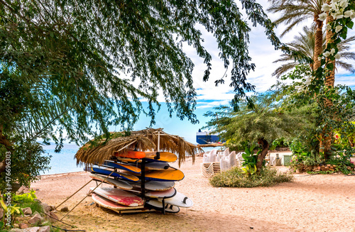 Stacked kayaks on sandy beach of the Red Sea near Eilat - famous tourist resort and recreational city in Israel 