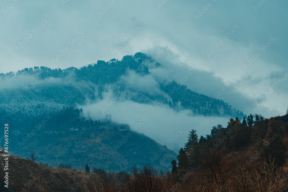 Clouds on the top of the mountain covered by snow after snowfall in Manali, Himachal Pradesh, India