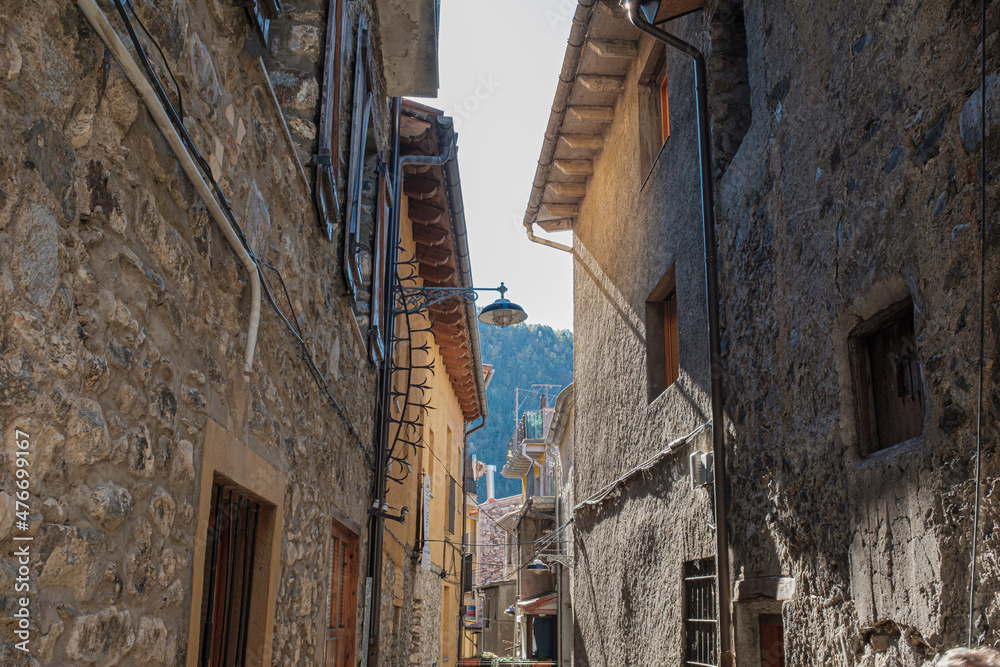 Narrow street on an old rock building facade medieval town