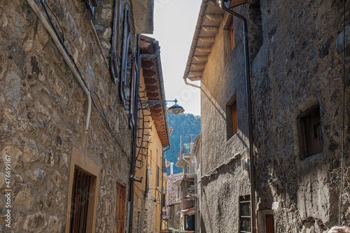 Narrow street on an old rock building facade medieval town photo