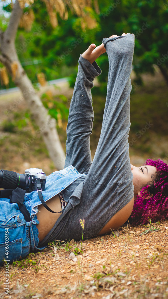 Fototapeta premium Girl who is dedicated to photography prepares from home to go to take photos of nature.