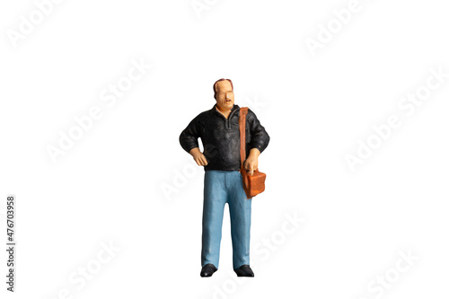 Miniature people Old man holding a shoulder bag  on white background with clipping path photo