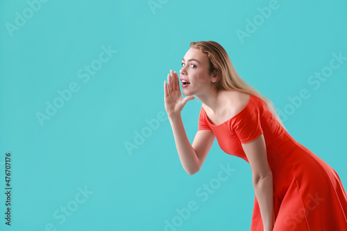 Young gossiping woman on color background