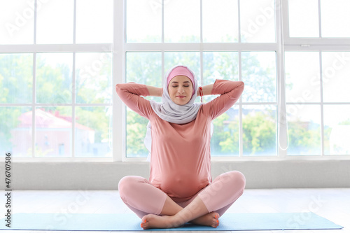 Young pregnant Muslim woman...