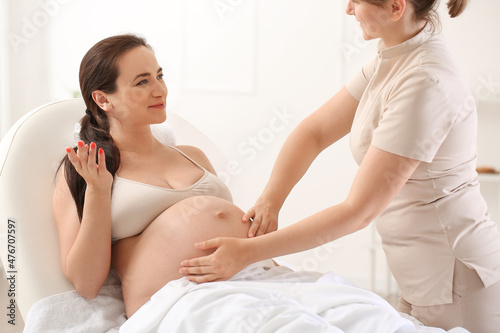 Young pregnant woman gettin...