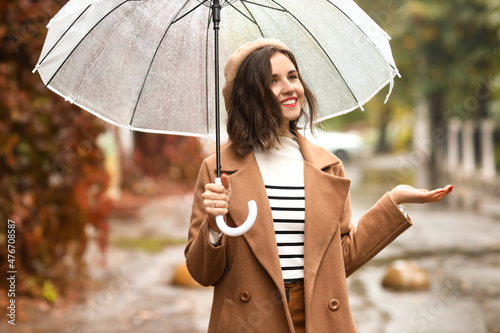 Young woman with umbrella e...