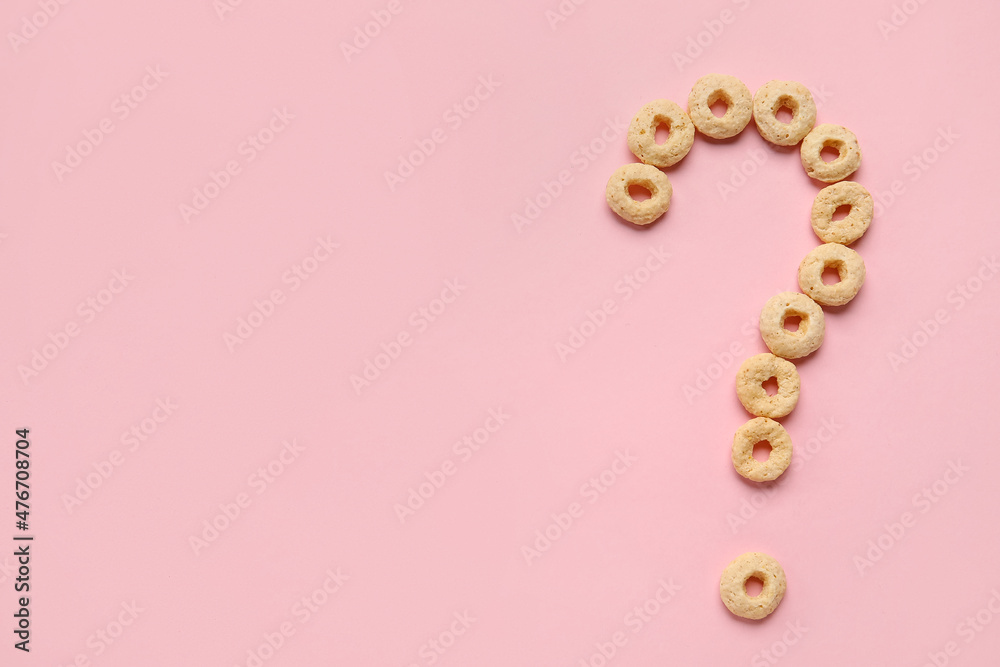 Question mark made of cornflakes on pink background Question mark made of cornflakes on pink background