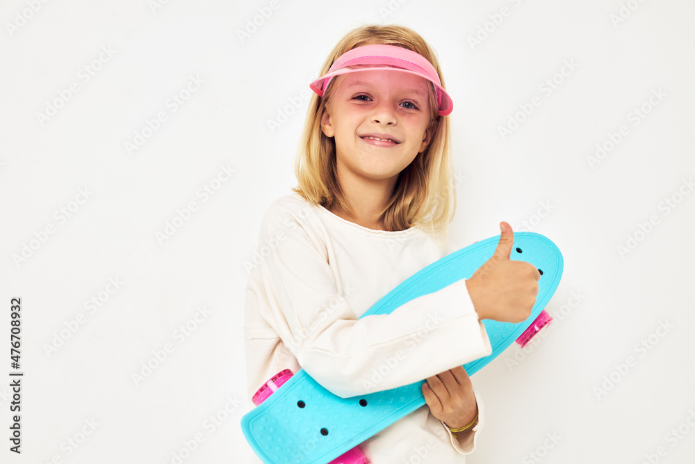 Portrait of young smiling kid pink cap with skateboard lifestyle childhood Portrait of young smiling kid pink cap with skateboard lifestyle childhood
