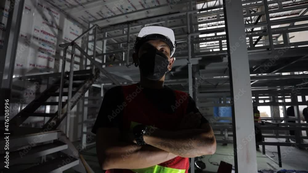 Technician, crouching, wearing a mask Technician, crouching, wearing a mask