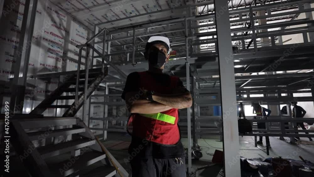 Technician, crouching, wearing a mask, construction worker Technician, crouching, wearing a mask, construction worker