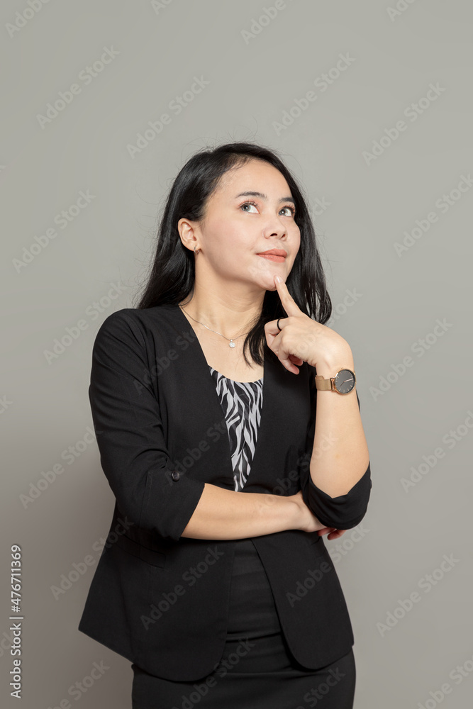 Young indonesian woman thinking with index finger on chin Young indonesian woman thinking with index finger on chin