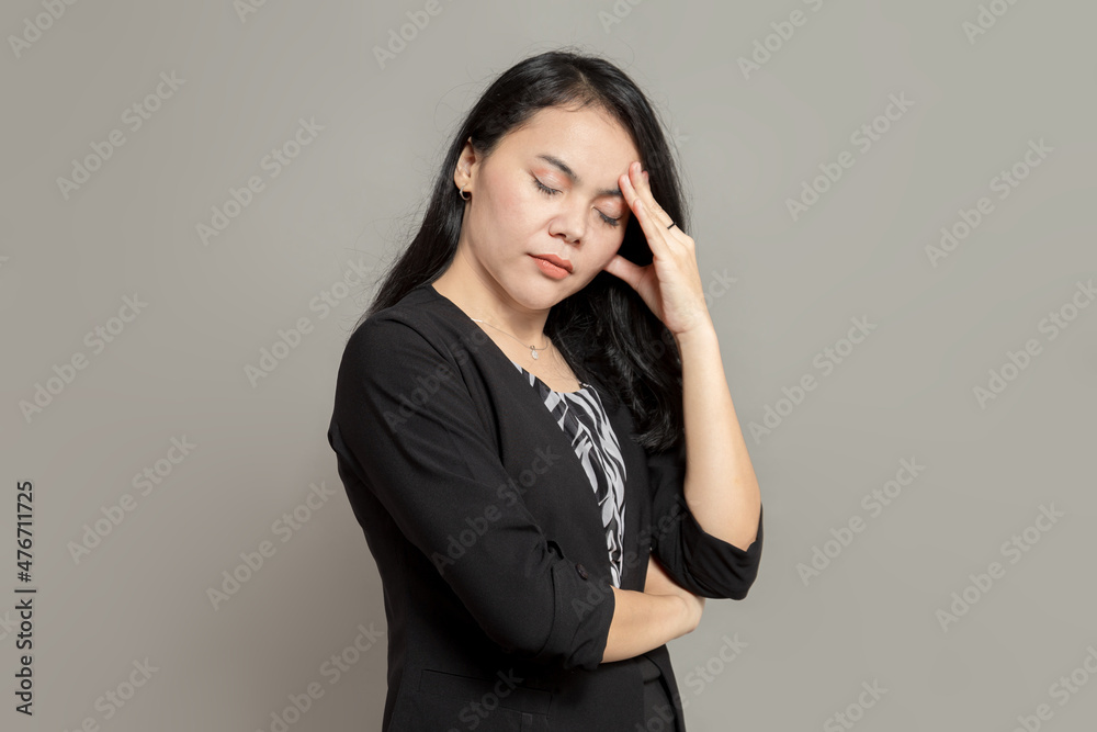 Business woman stressed expression while holding her head and closing her eyes Business woman stressed expression while holding her head and closing her eyes