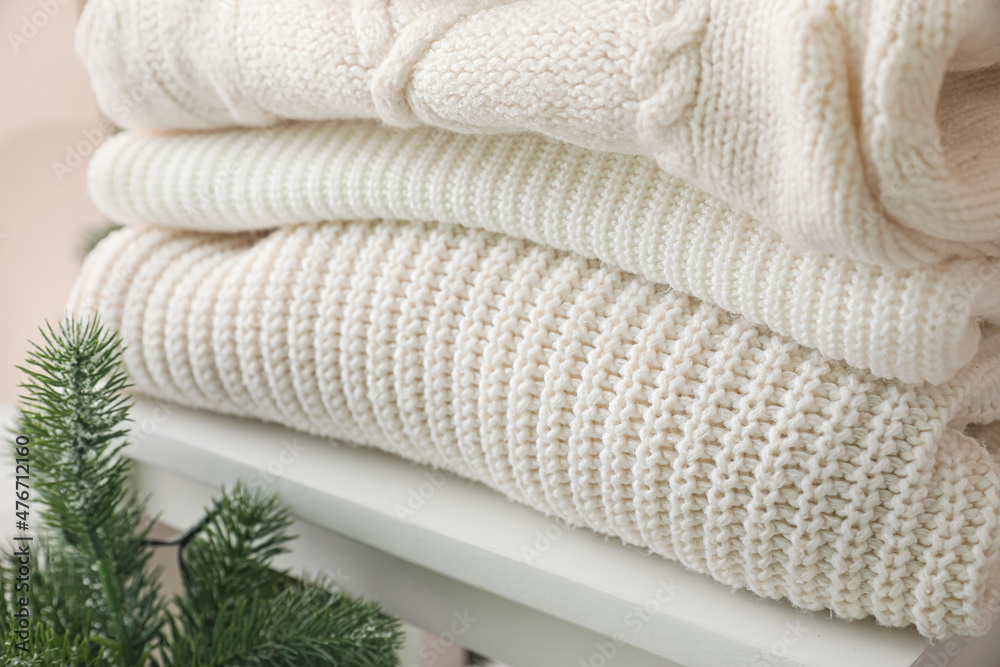Step ladder with warm winter sweaters, closeup Step ladder with warm winter sweaters, closeup