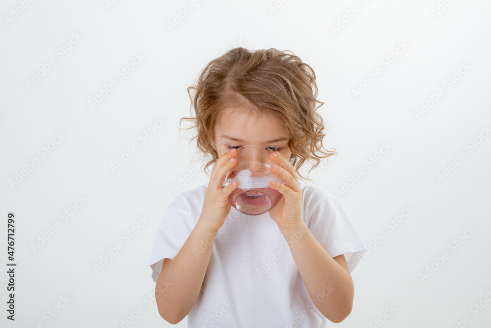 little cute girl drink of water, pours water into a glass isolated on a white background little cute girl drink of water, pours water into a glass isolated on a white background