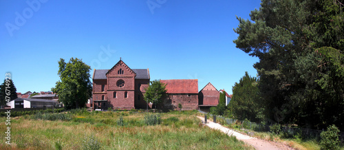 Panoramic village view of a meadow and the romanesque monastery church of Enkenbach near Kaiserslautern, Pfalz region in Germany