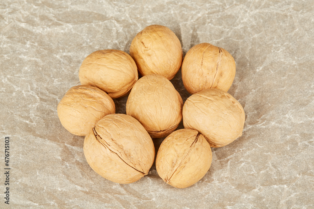 Walnuts in the center lie on paper Walnuts in the center lie on paper