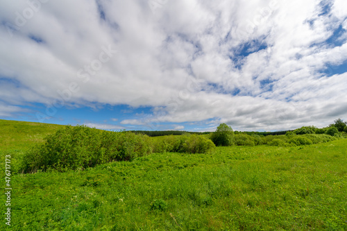 Spring photography  meadows  fields  ravines  hills  rural landscape. A deep  narrow gorge with steep slopes. A naturally raised area of       land  not as high or craggy as a mountain.