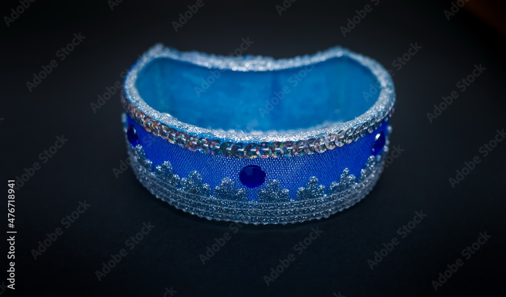 Obraz premium Purchased blue candlestick close-up on a black background