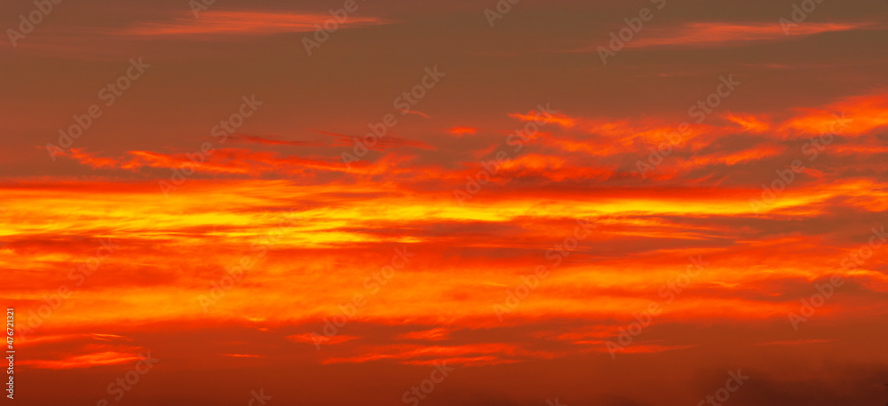 Photo of the sky with clouds, sunrises, sunsets, orange-yellow tones from the setting sun