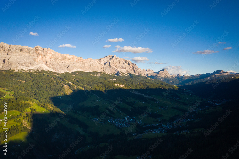 aerial view of illuminated dolomites mountains by the sun in the morning