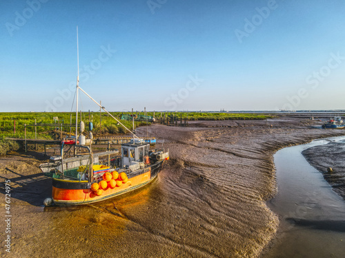 Small fishing boats moored in the Stone Creek inlet at Sunk Island, East Yorkshire, UK photo