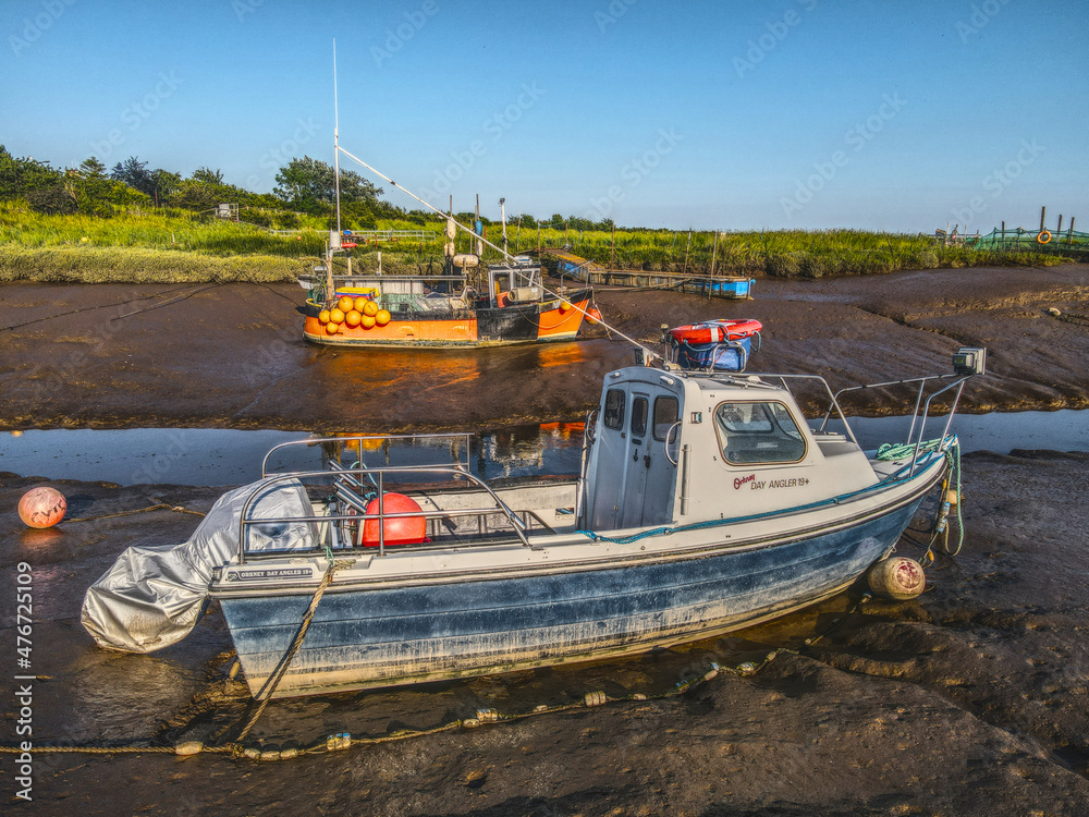 Small fishing boats moored in the Stone Creek inlet at Sunk Island, East Yorkshire, UK
