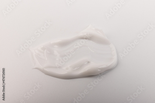 White smear of cosmetic cream isolated on light background.