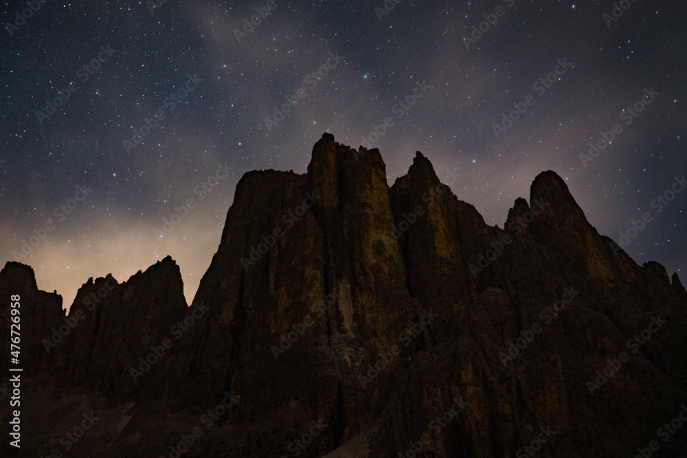 starry night over mountain peaks in the dolomites alps at night starry night over mountain peaks in the dolomites alps at night