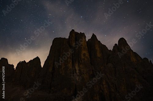 starry night over mountain peaks in the dolomites alps at night