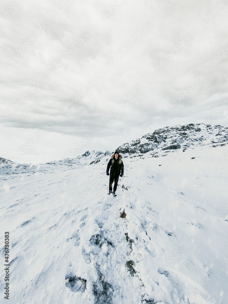 Hiker in the snowy mountains. 

Ben Narnain, Scotland. Located in the southern Highlands of Scotland, near Arrochar. It forms part of a group of hills known as the Arrochar Alps, and 