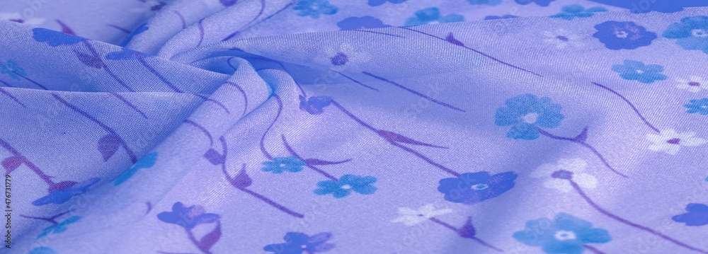 Texture background pattern, silk fabric, small flowers on a lilac background, thin line of azure tone with print. Floral design.