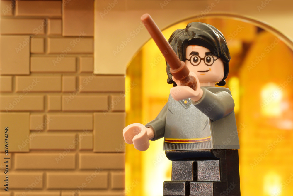 Naklejka premium Lego minifigures Harry Potter with magic wand clossed up. Editorial illustrative image of literatur fairy tail scene.