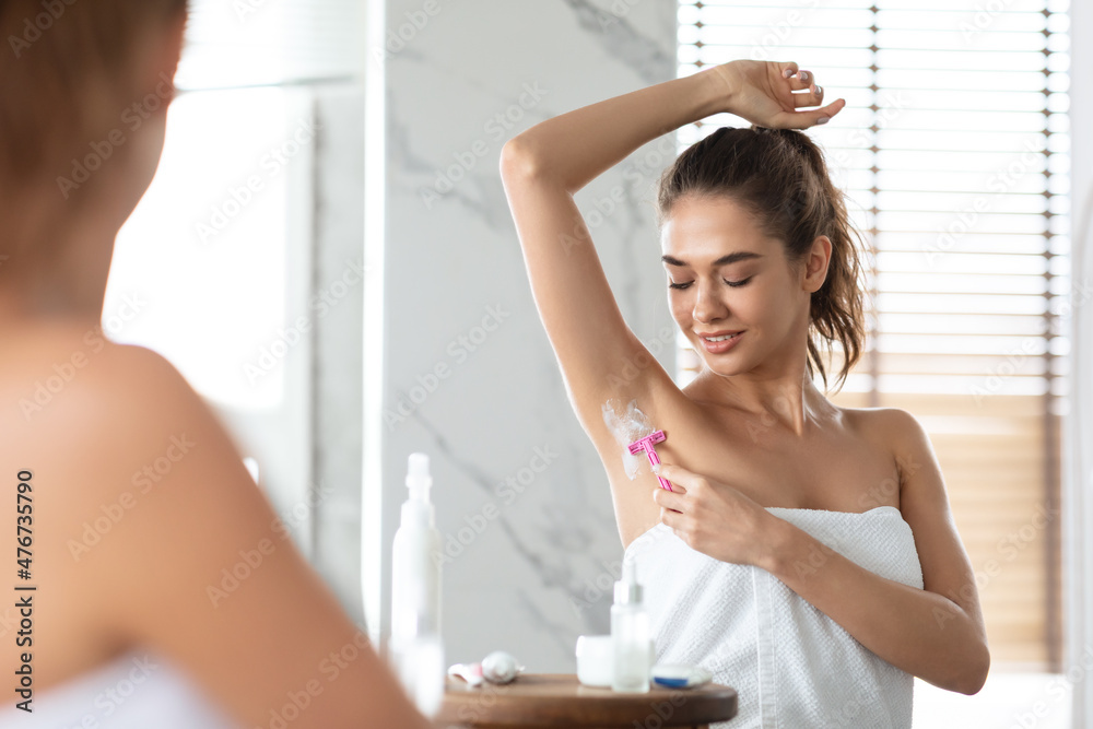 Female Shaving Armpits Removing Underarms Hair With Razor In Bathroom