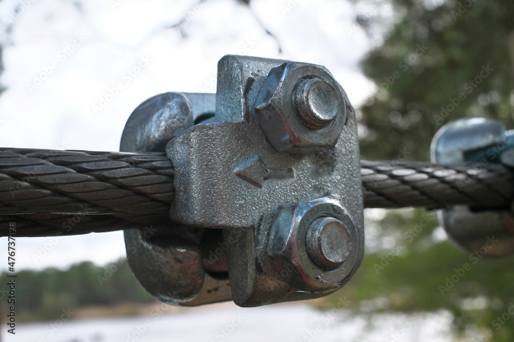 Metal staples for fastening steel cables. Connect the two cables to metal fastening strength. Selective focus.