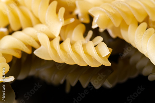 Short pasta. Fusilli, commonly known as rotini in the United States, is a variety of pasta that has a corkscrew or spiral shape. The word fusilli is believed to be derived from fuso (