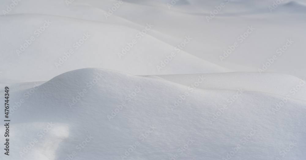 Snow texture atmospheric water vapor frozen into ice crystals and falling in light white flakes or lying on the ground as a white layer.