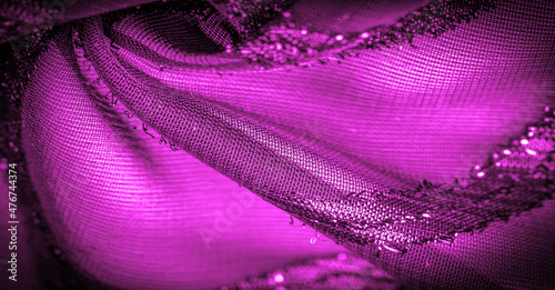 the ornament of the decor, the transparent fabric is purple-red with brightly innate stripes, the material allowing the light to pass through it so that the objects behind are clearly visible