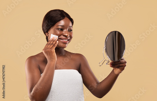 Smiling Black Woman Using Matt Control Blotting Papers And Looking In Mirror