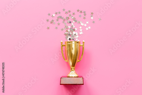 Championship award golden trophy cup with shiny stars
