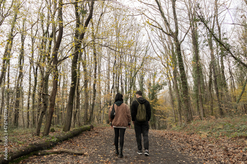 A boy and a girl walking on the forest. Friendship concept photo.