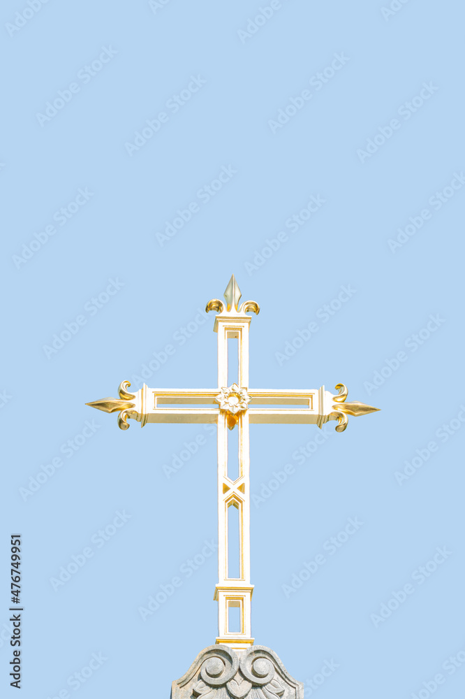 Ancient monastery golden cross at blue sky solid background with copy space. Concept of religious and historic heritage. Ancient monastery golden cross at blue sky solid background with copy space. Concept of religious and historic heritage.