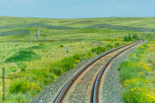 railway, railroad, rail, elevated. steppe prairie veld. is a means of transportation and passengers of trucks moving on rails that are located on the rails of the Great Plains. Kazakhstan 