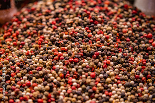 Close up of Mixed multi colorful peppercorns. White, black and green peppercorns macro background.