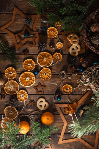 Dried slices of oranges cut into circles lie on a wooden table. New Year's Flatley